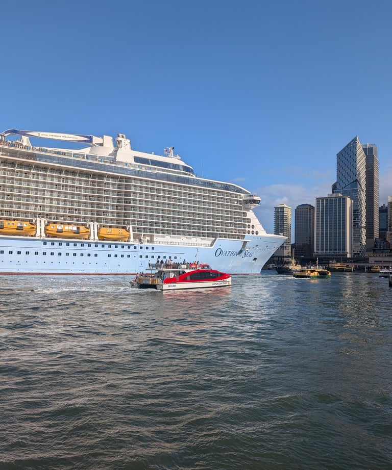 ferry next to cruise ship in Sydney Harbor