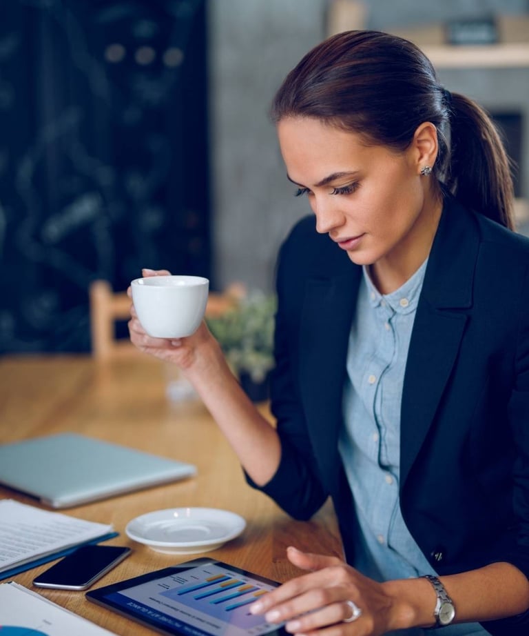 a woman in a suit and a cup of coffee