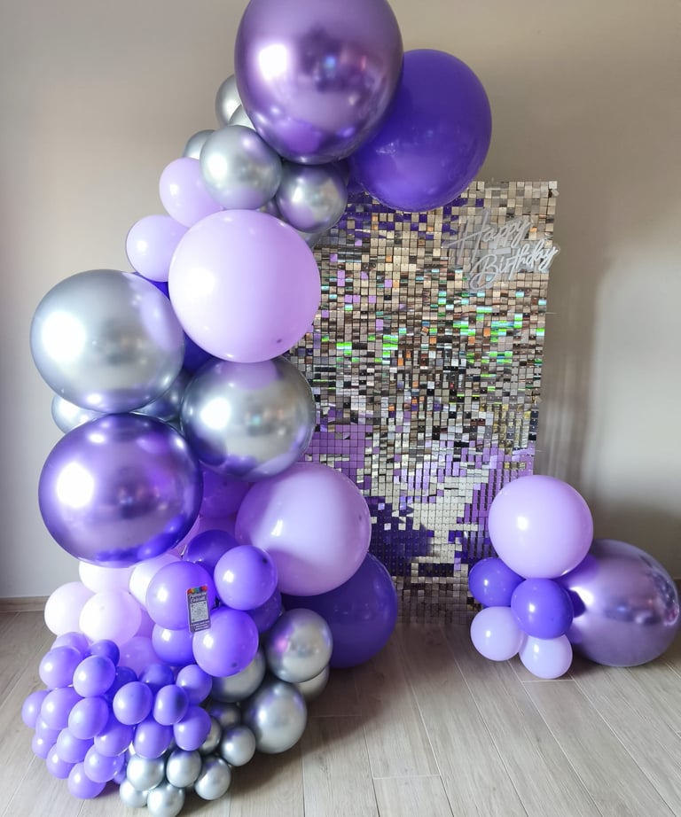 a bunch of balloons and balloons are arranged on a table