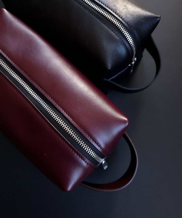 Burgundy and black leather toiletry bags 