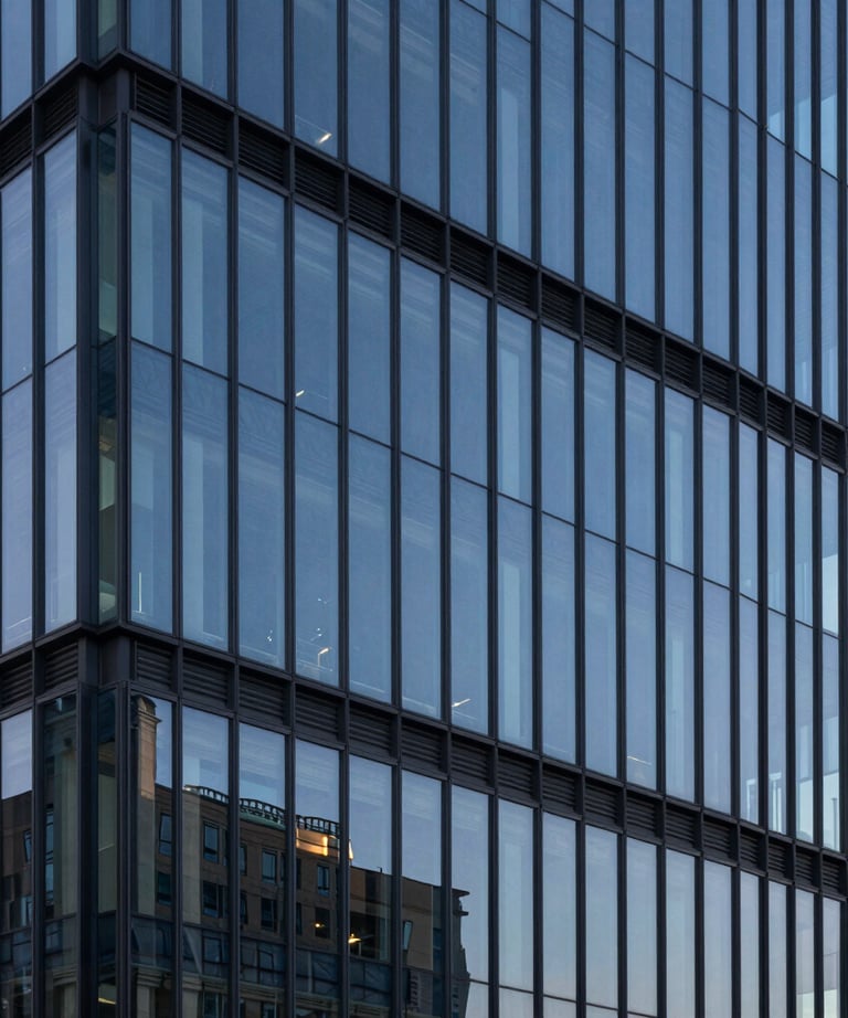 A minimalist architectural detail of a high-tech North American office building at dusk. The glass reflects steel blue and slate navy tones, symbolizing modern efficiency and the solid foundation of digital tools.