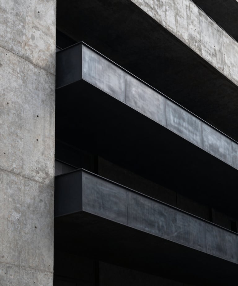 Modern urban South American architectural detail, black steel and concrete, moody shadows, minimalist and powerful.