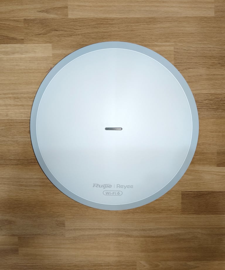 a round white clock with a white clock on it