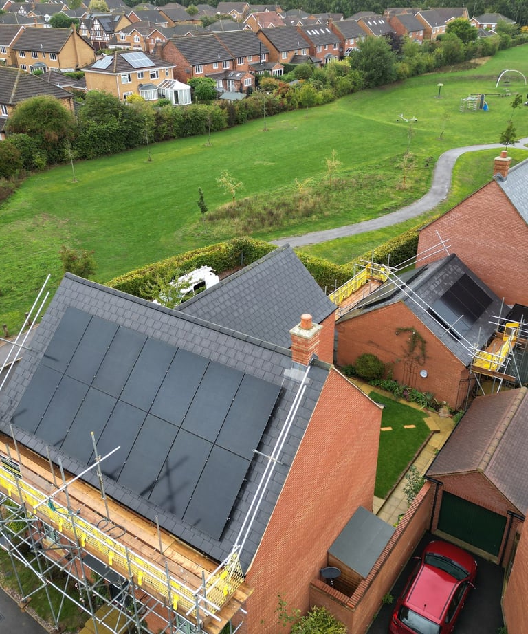 Aerial view of solar panel installation on a residential brick house in Brackley.