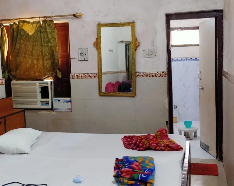 a bed with a white bed and a microwave