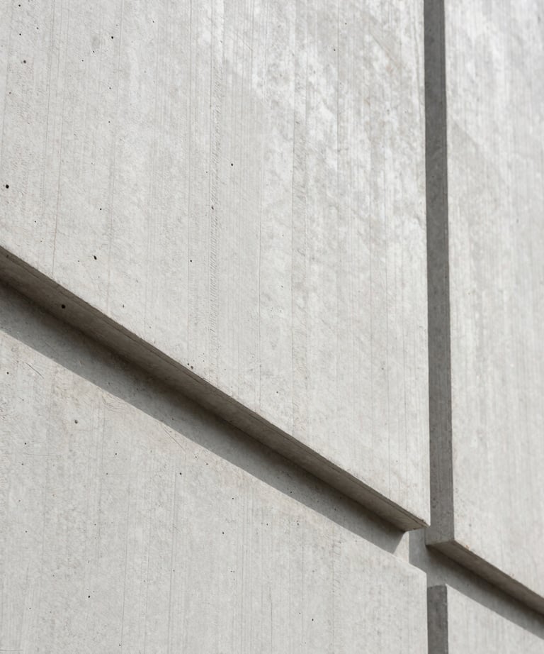 Details of architectural concrete and wood textures. Clean lines, minimalist photography in light gray and off white.