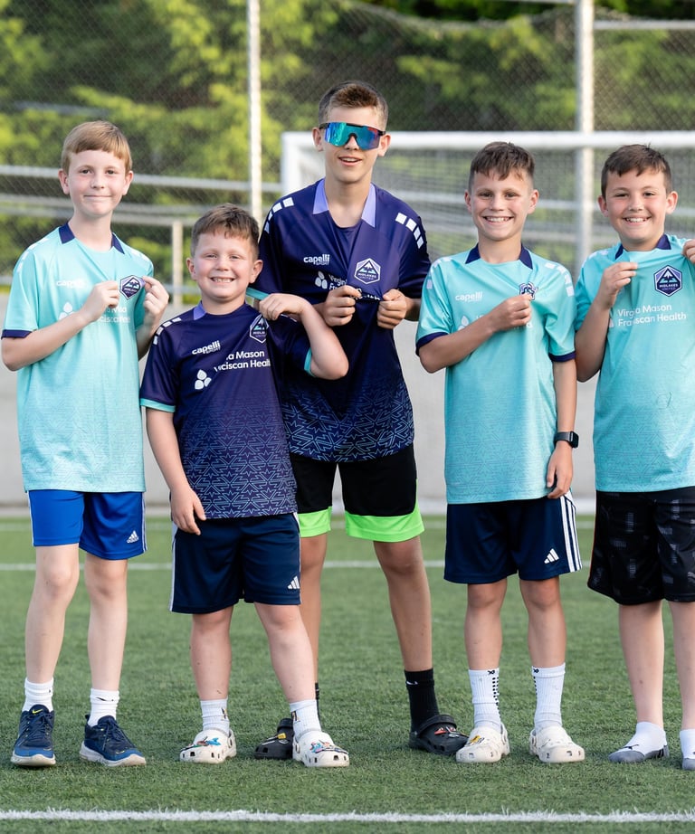Boys wearing Midlakes jerseys and highlighting the Midlakes United  crest.