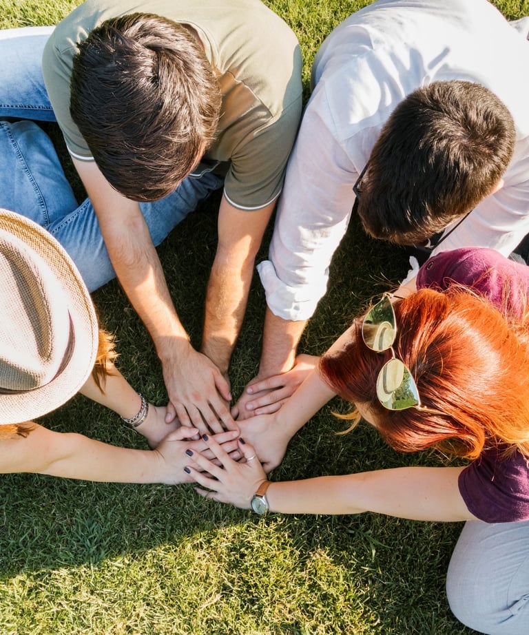 a group of people siting around a group of hands