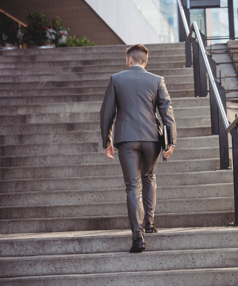 a man in a suit walking up stairs
