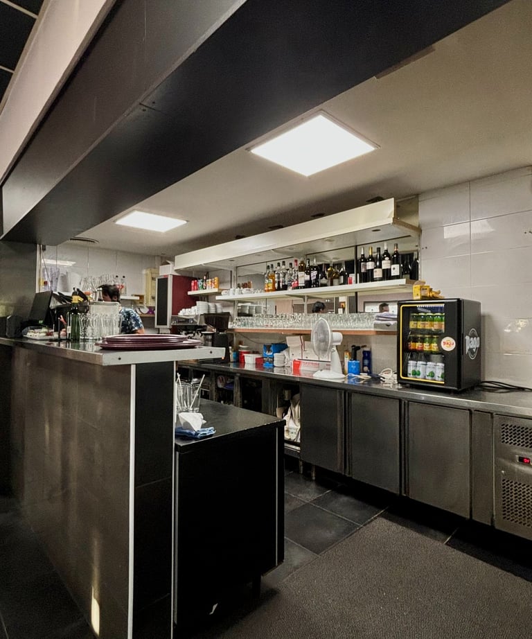 a kitchen with a large counter top and a refrigerator