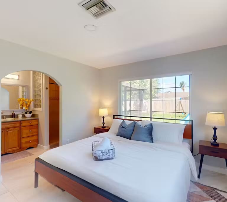 a bedroom with a bed and a mirror