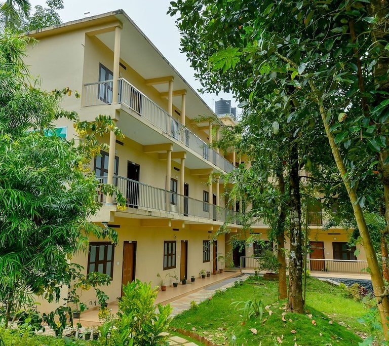 Beautiful exterior of Gooseberry Family Retreats in Wayanad, featuring well-maintained gardens and l