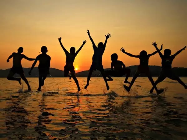 a group of people jumping in the air green Way Association