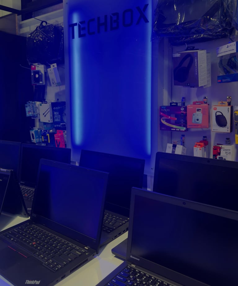 a row of laptops with a blue light on the wall
