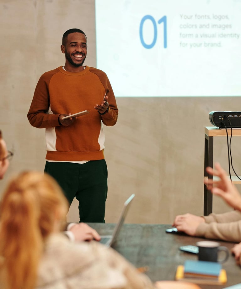 a man standing in front of a presentation on a projector