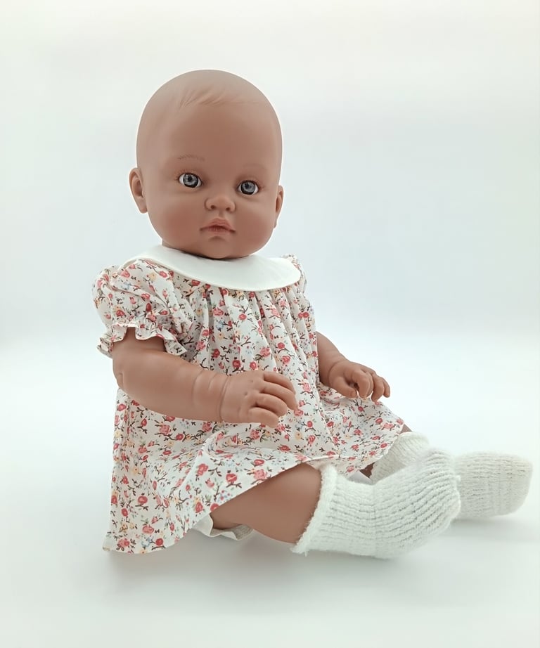 Minikane doll in cream floral dress with cream collar