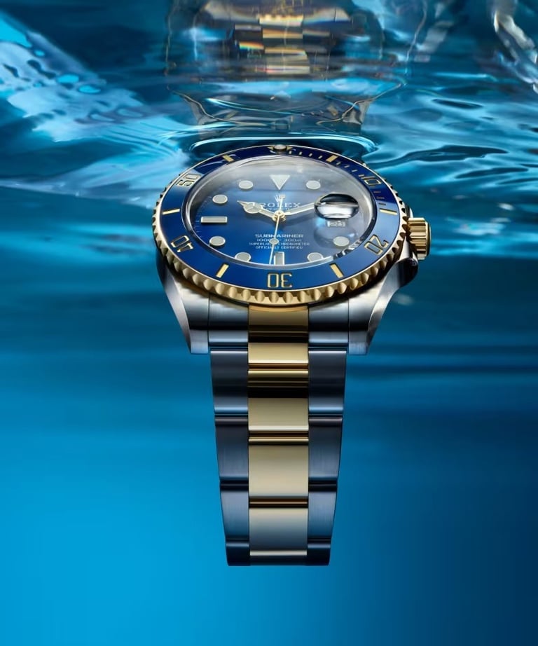 Rolex Submariner with a blue dial and gold accents, showcasing luxury and precision.