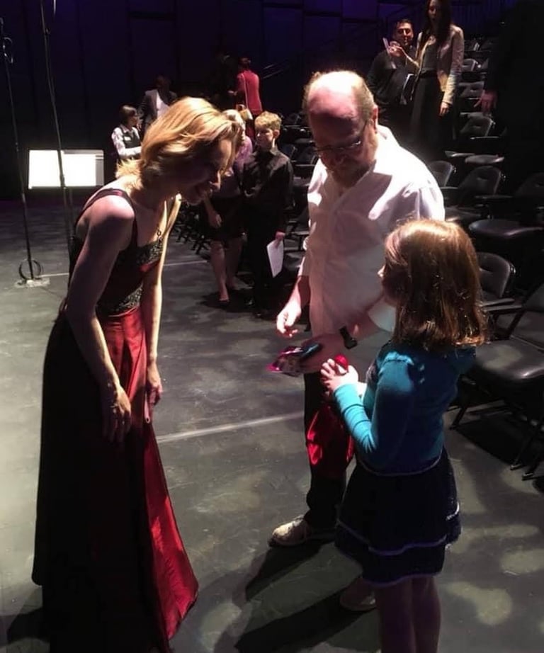 Violinist performer and teacher greets her future student and their parent after a concert