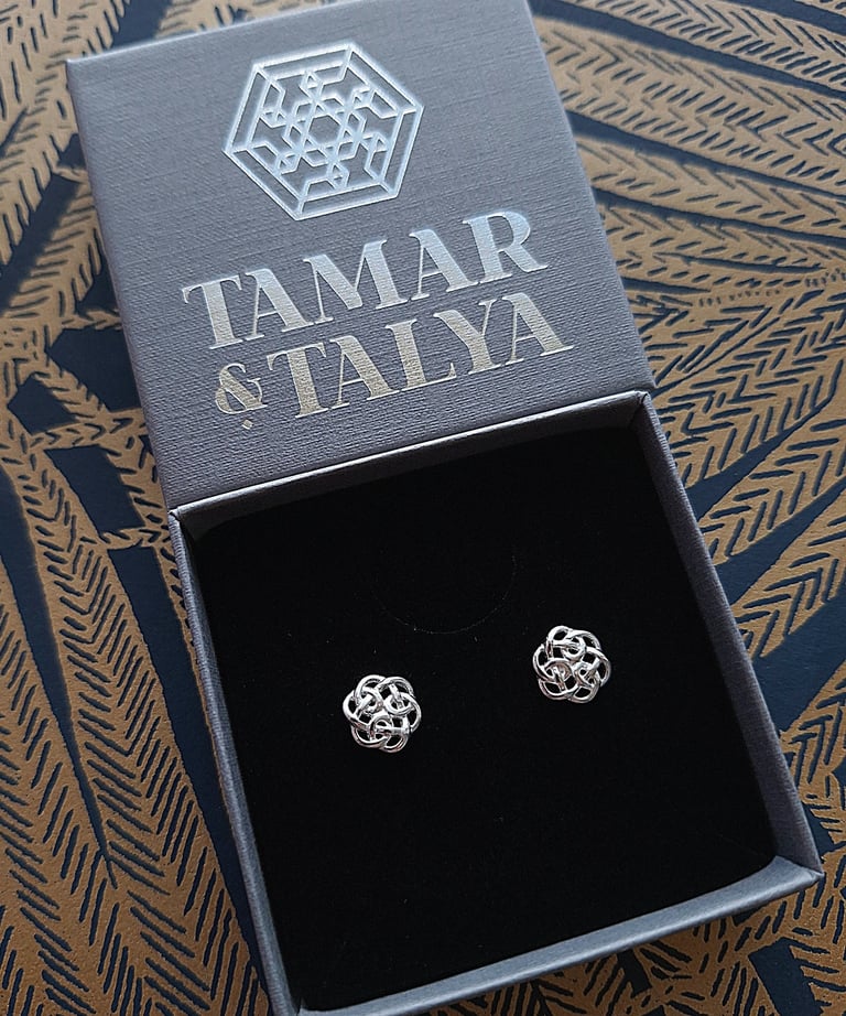 Handmade silver Celtic knot stud earrings in a branded Tamar and Talya jewelry gift box.