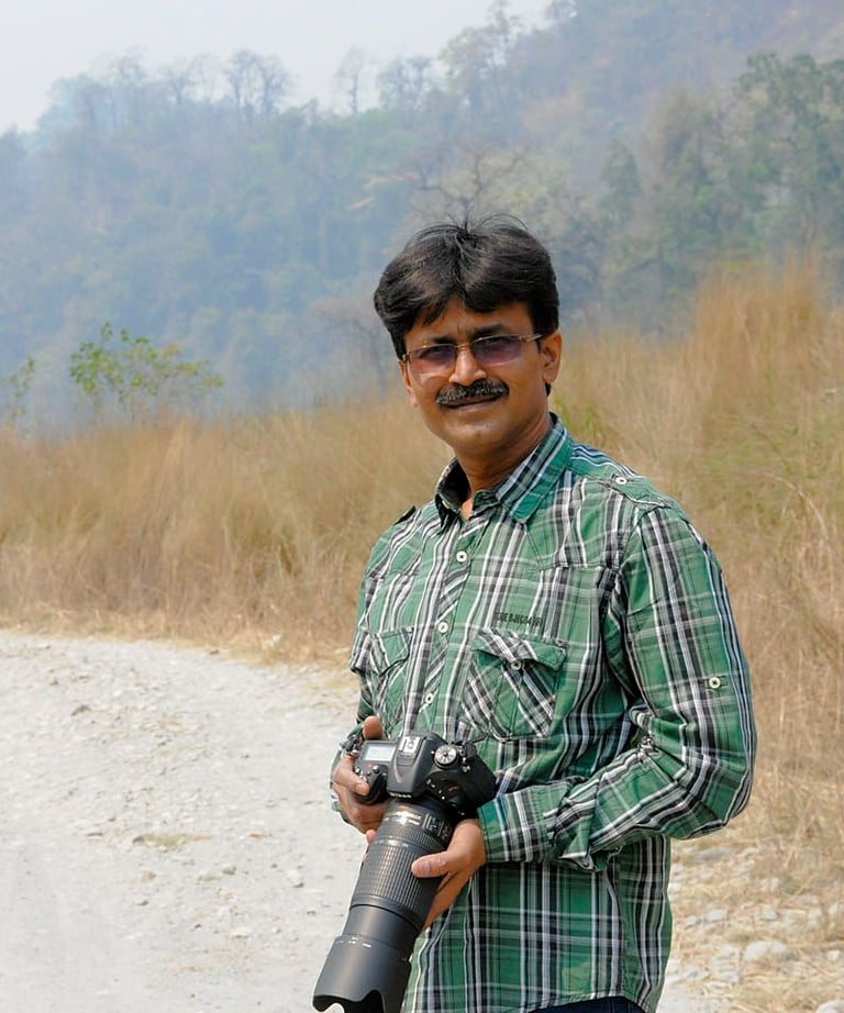 The cameraman is standing with his camera looking towards the front.