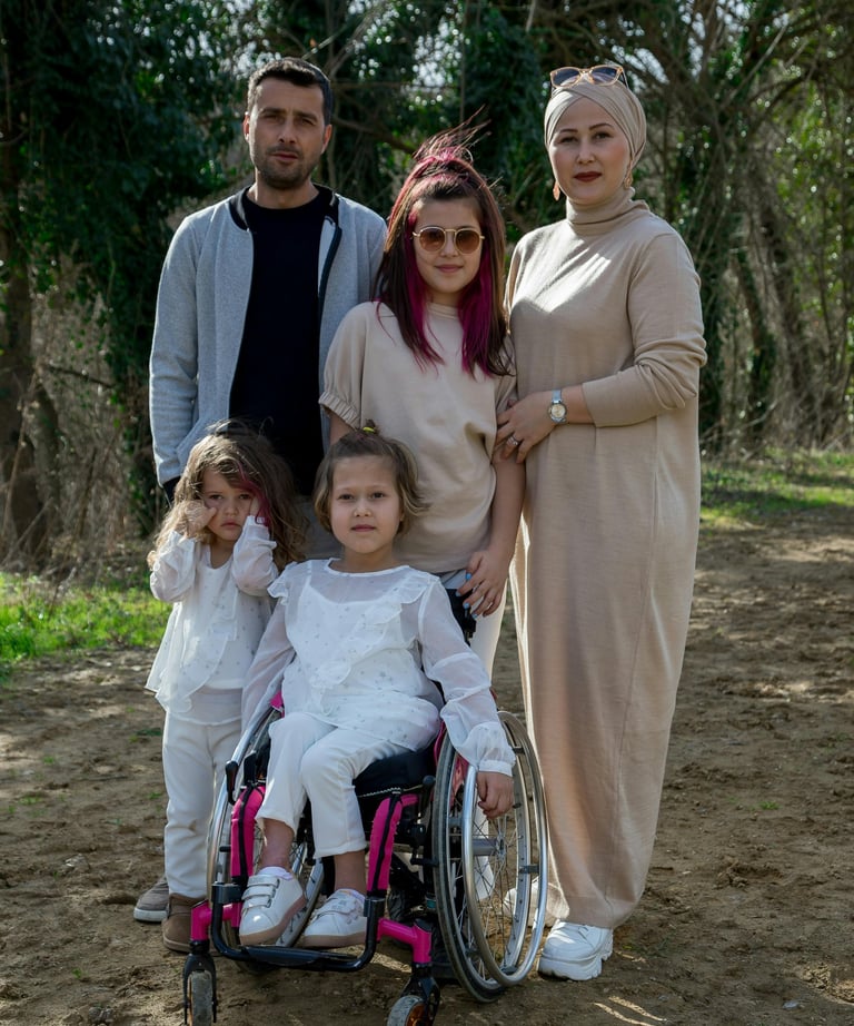 a family posing for a picture in a park