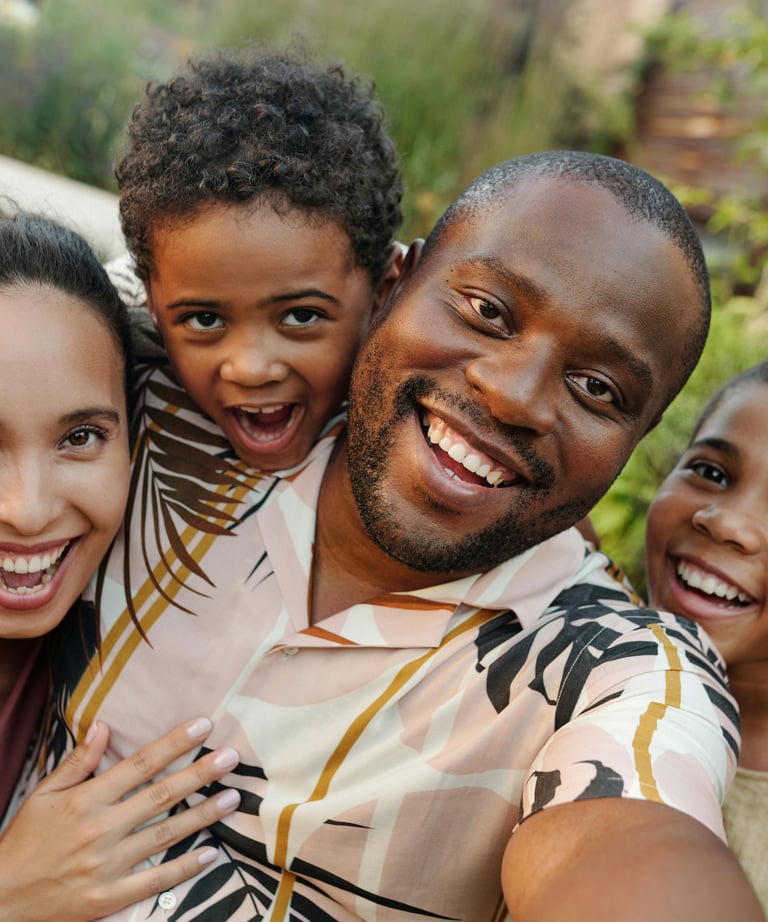 a family of three smiling and posing for a photo