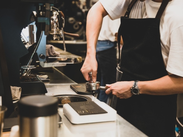 a barista making coffee