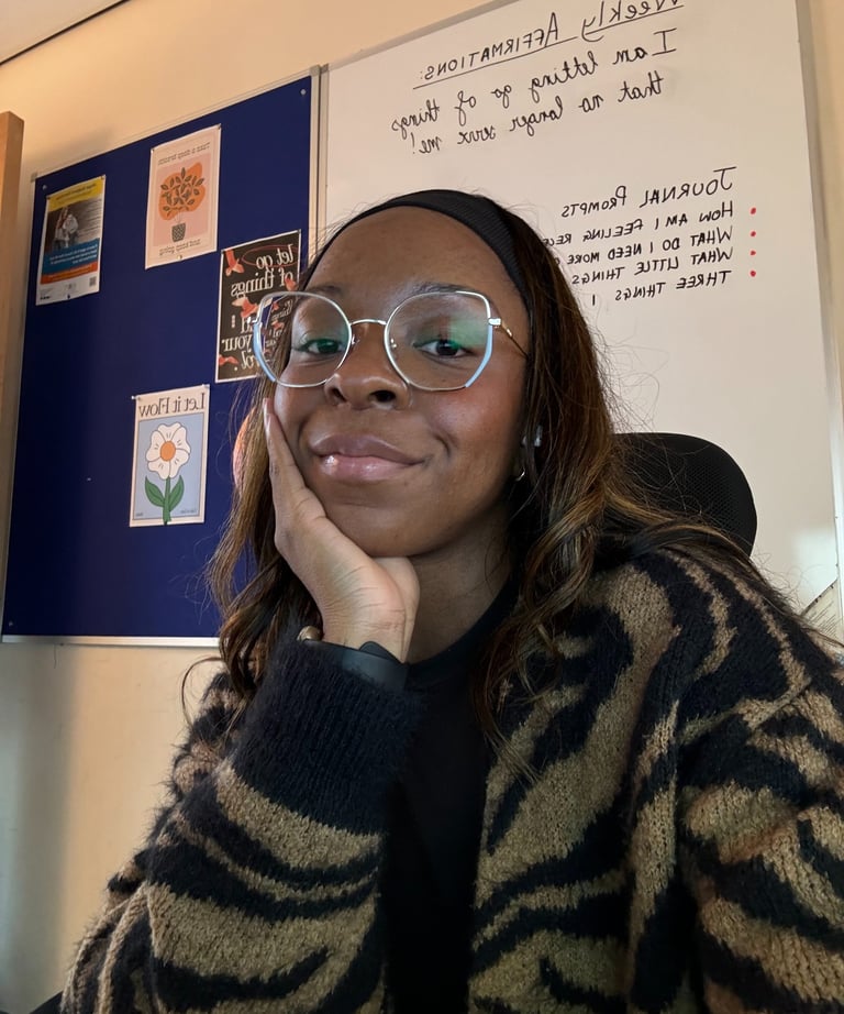 picture of Lisa Danso-Obeng from LDO Counselling in front of a board with affirmations and prompts