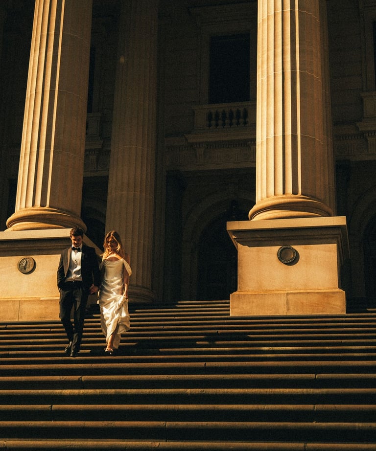 Bride and groom walking down Parliament House stairs Melbourne – cinematic wedding photography