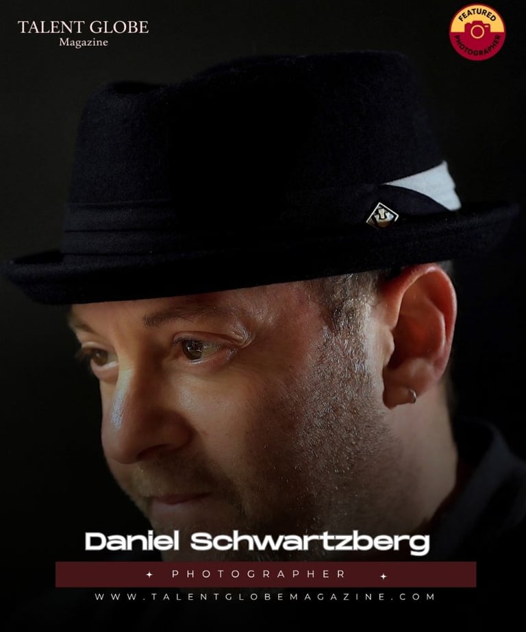 Portrait of photographer Daniel Schwartzberg wearing a black fedora for Talent Globe Magazine.
