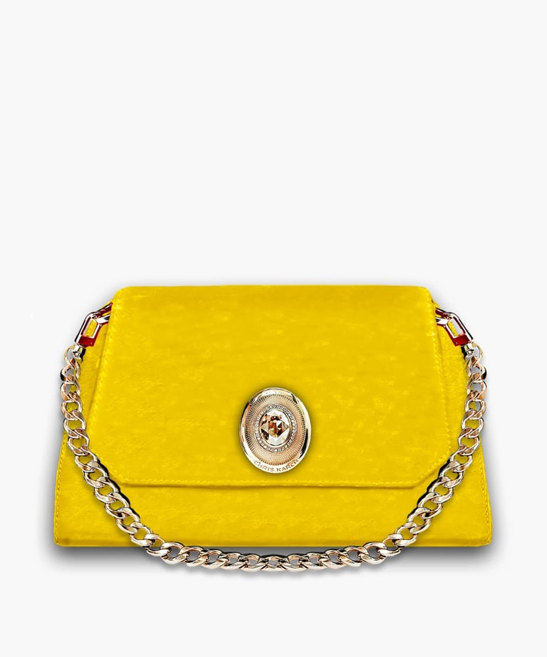 Vibrant yellow designer clutch bag with a gold chain strap and ornate metal emblem.