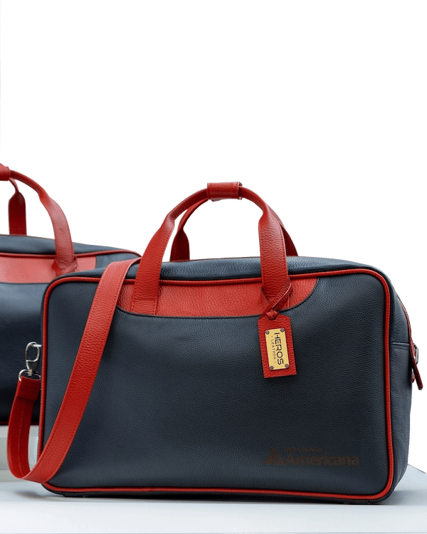 two bags of luggage with a red and blue one by heros leather