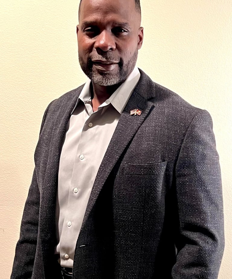 Dr. Marlon Ware standing in casual suit