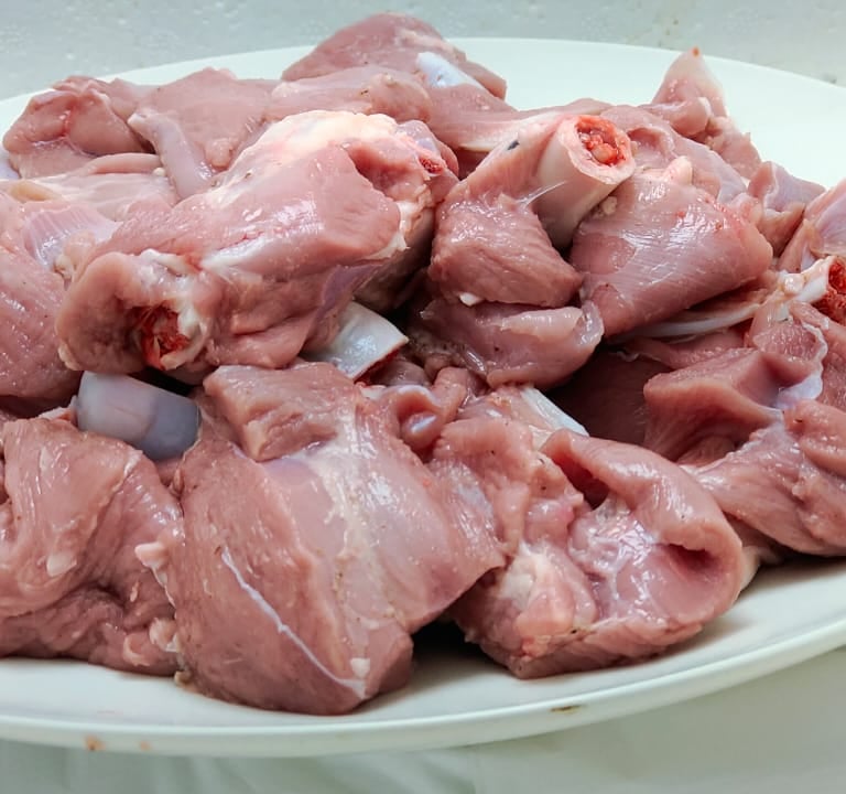 a plate of cuts raw meat with meat on it