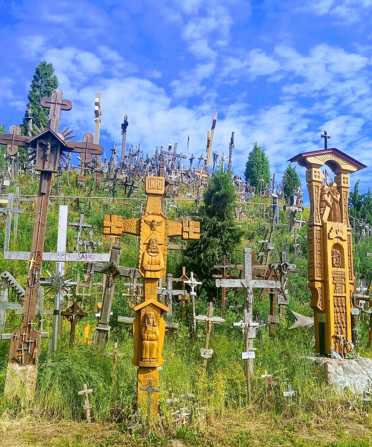Traditional wooden and metal crosses at the Hill of Crosses pilgrimage site in Lithuania.