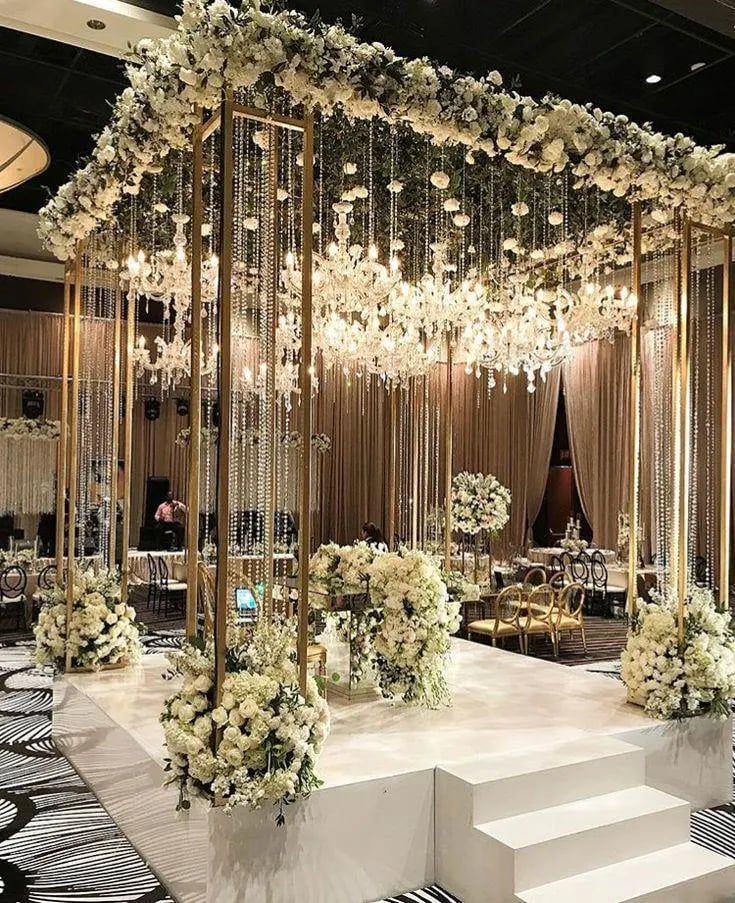 Luxury wedding hall decor with chandeliers and floral centerpieces by Amika Weddings in Pune.
