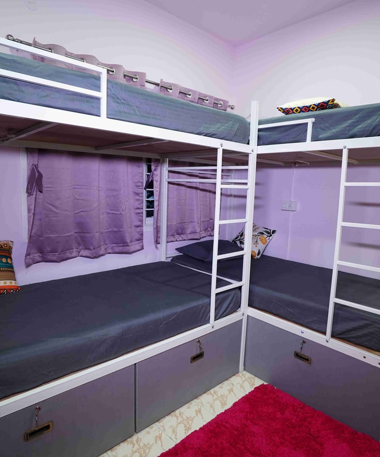 Two bunk beds and a dark pink rug