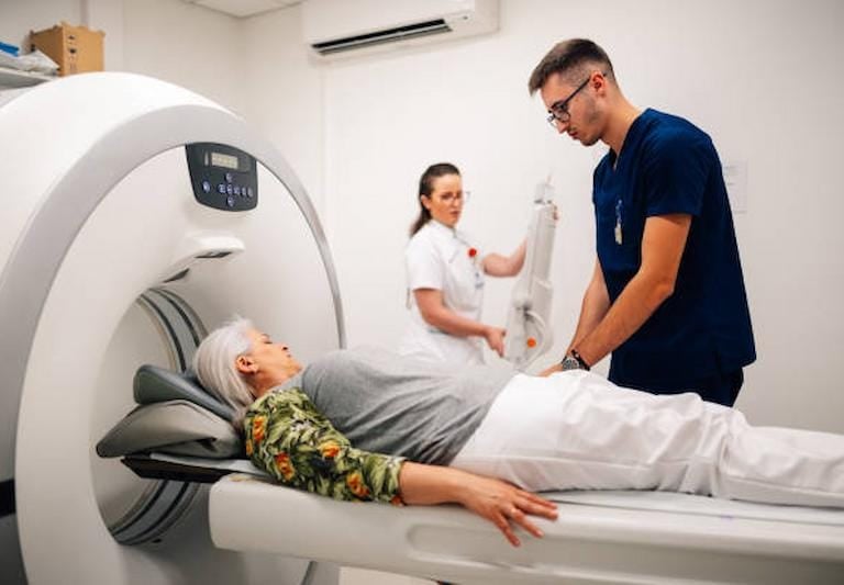 Doctor assisting a patient inside a modern MRI scanner at a diagnostic center in Delhi.