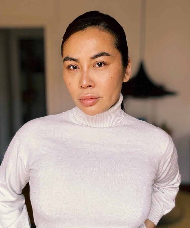 a woman in a white turtle neck sweater
