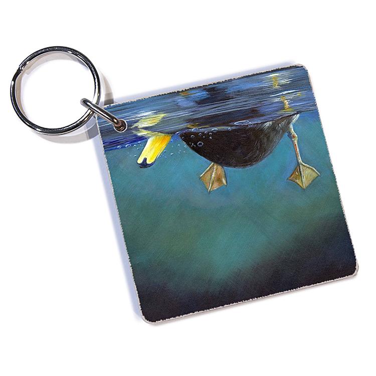 a keychain with a picture of a duck swimming in the ocean