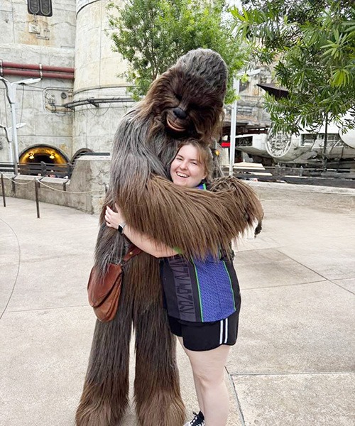 Sarah Brewer pictured with Chewbacca inside Galaxy's Edge inside Disney's Hollywood Studios® Park.