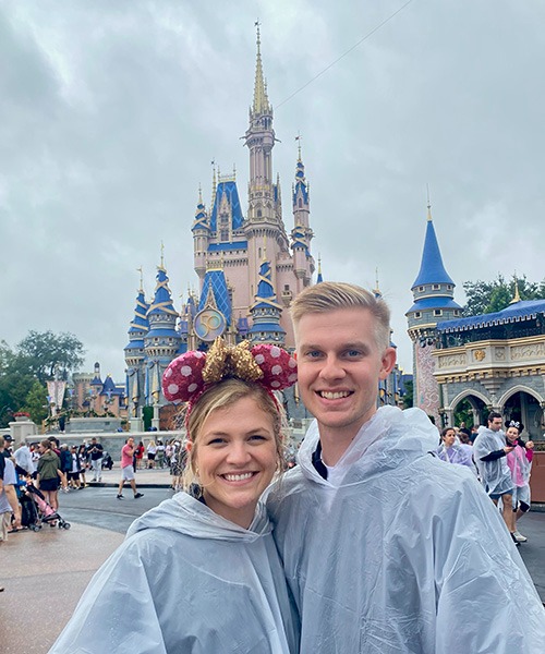 Kasey Kalk pictured with her husband in front of Cinderella Castle at Disney's Magic Kingdom®.