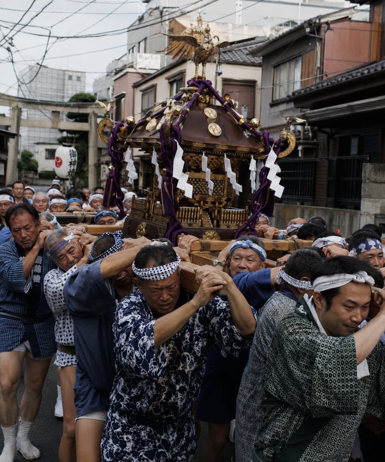 Japanese men carrying a golden mikoshi portable shrine during a traditional Shinto festival parade.