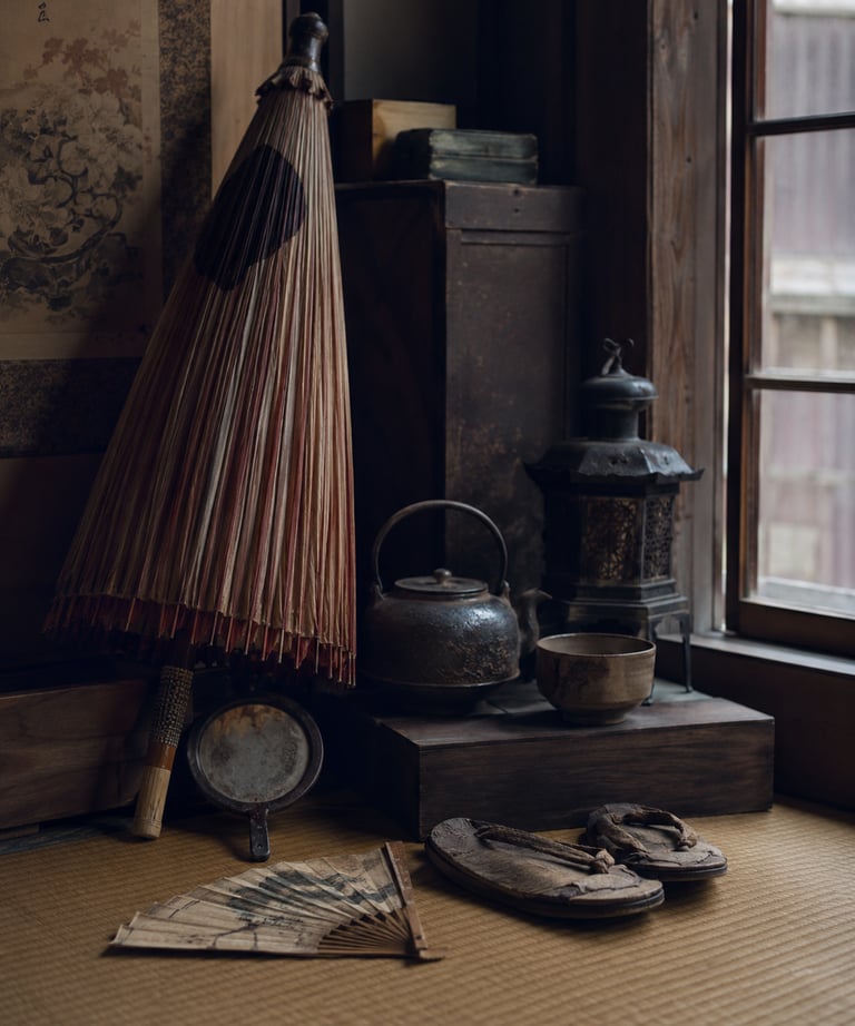 Vintage Japanese interior with a wagasa paper umbrella, tetsubin kettle, and traditional Geta sandals on tatami matting.
