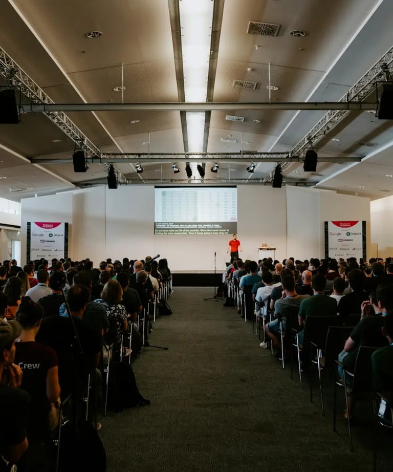Speaker presenting ideas to a small attentive audience in a cozy space