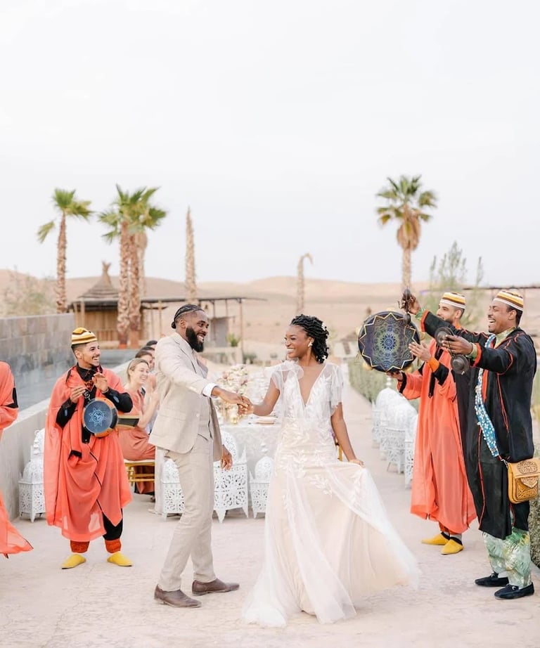 a bride and groom are dancing in a desert