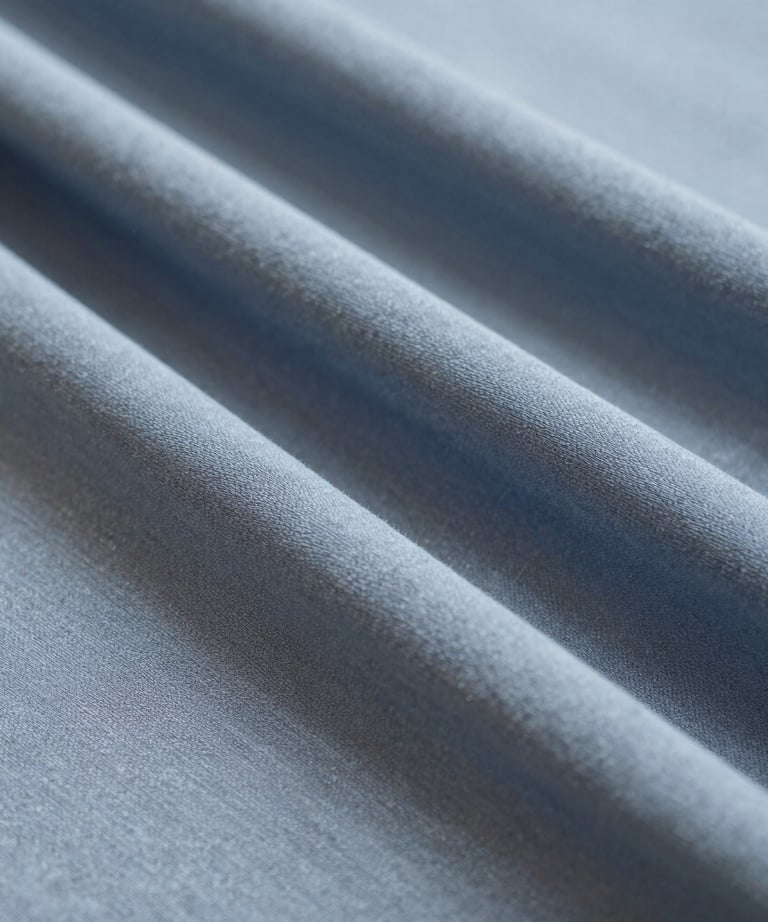 Close-up of soft fabric textures and intricate embroidery on a hijab.