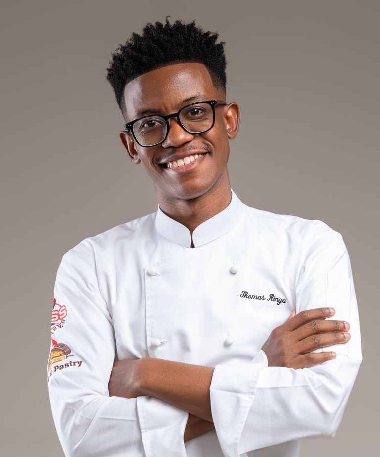 a man in a chef's uniform and glasses