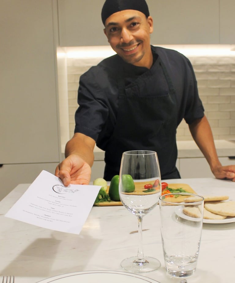 a man in a chef's uniform is holding a piece of paper