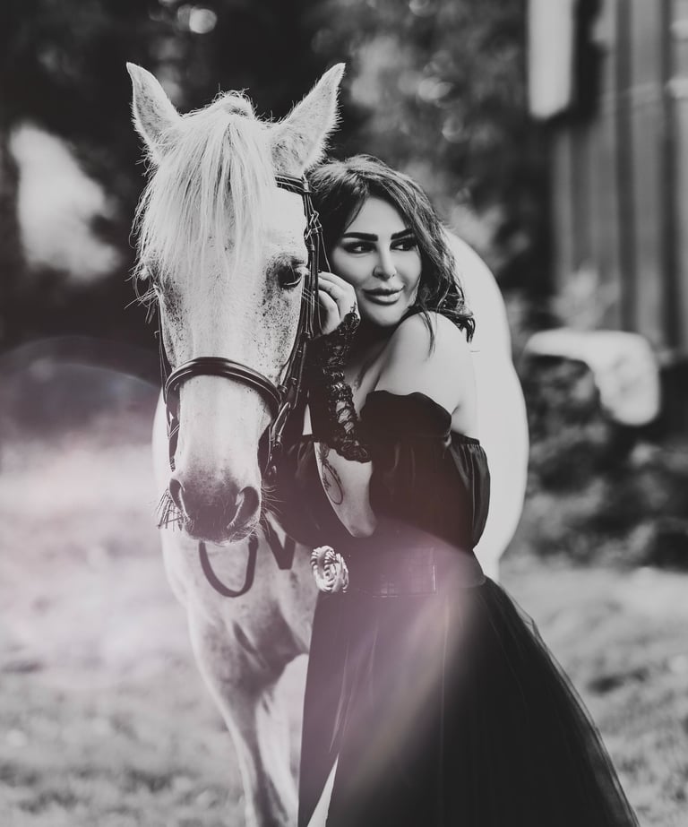 Black and white portrait of model with white horse, captured by Fred Art Studio.